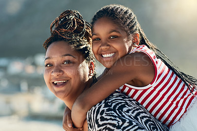 Buy stock photo Portrait of a mother and her little daughter enjoying some quality time at the beach