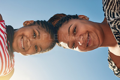 Buy stock photo Portrait of a mother and her little daughter standing with their heads together outside