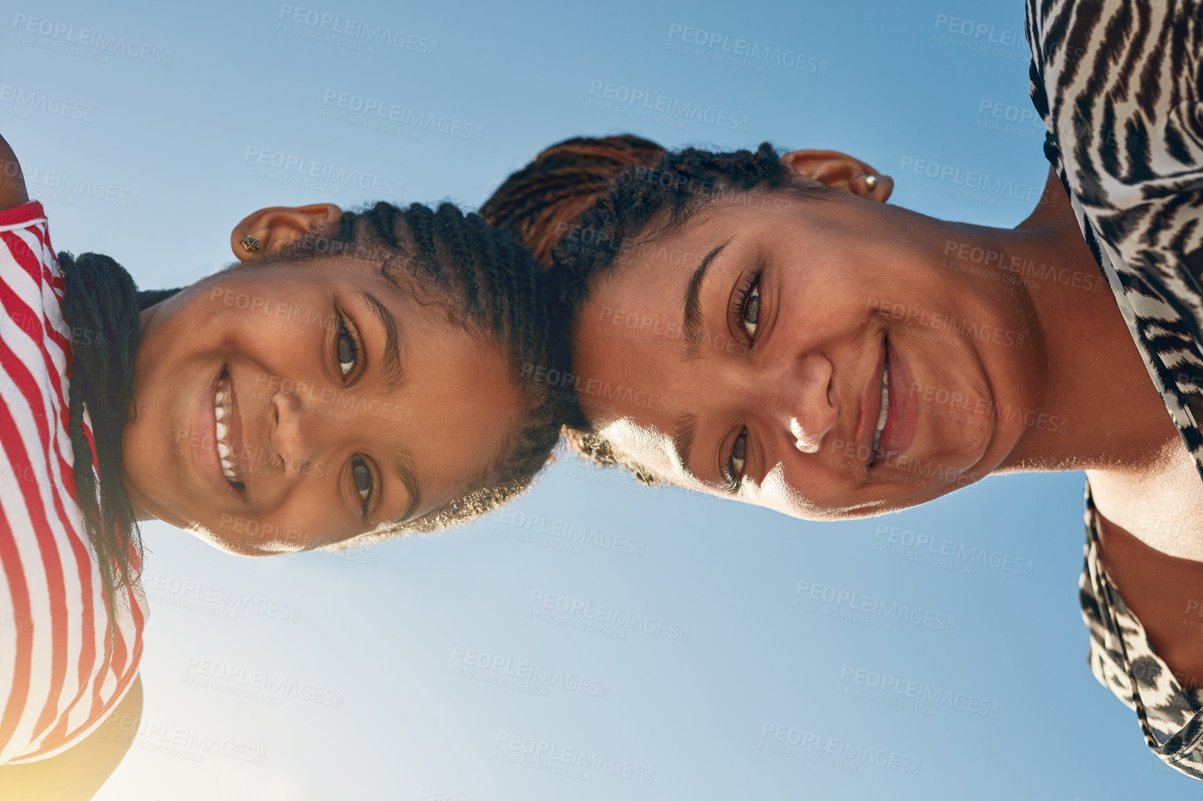 Buy stock photo Portrait of a mother and her little daughter standing with their heads together outside