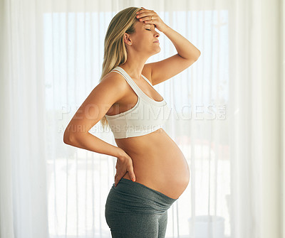 Buy stock photo Shot of a pregnant woman looking uncomfortable