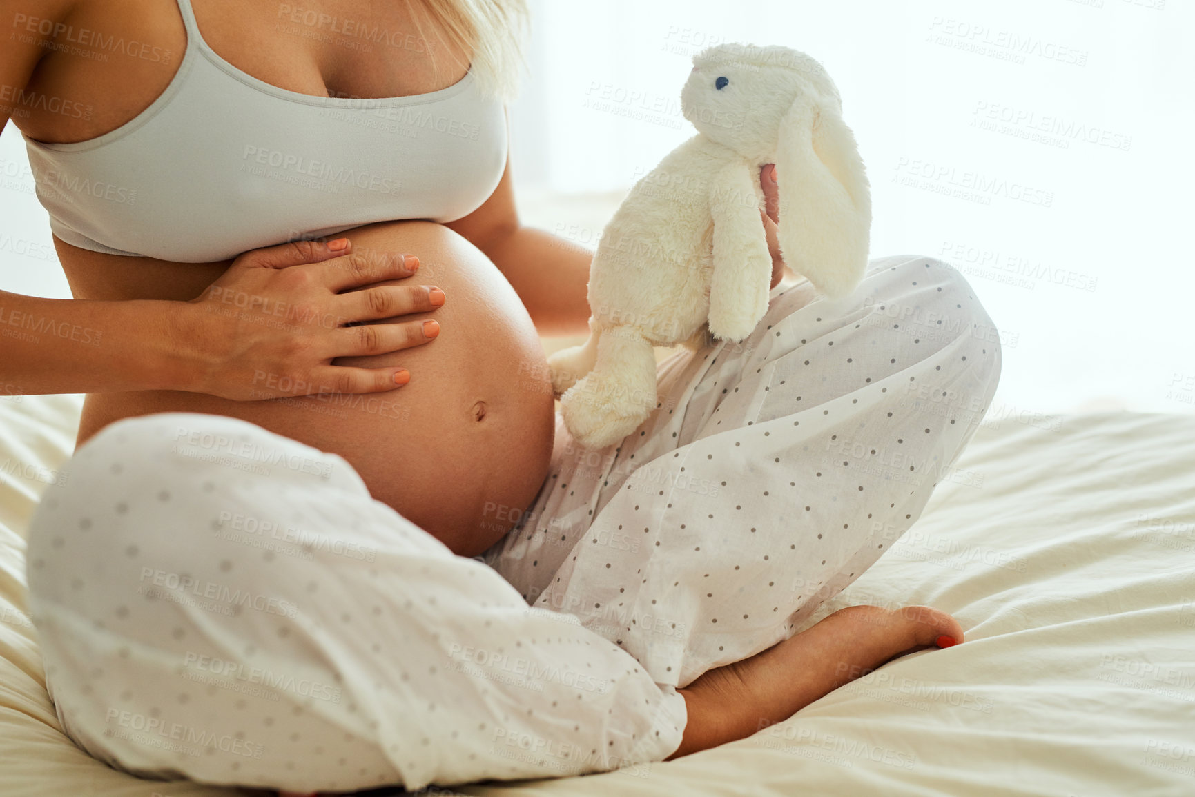 Buy stock photo Pregnant, woman and home on bed with belly, expecting mother and maternity leave in apartment. Gestation, baby toy and family planning for future in house, stomach growth and bedroom for pregnancy