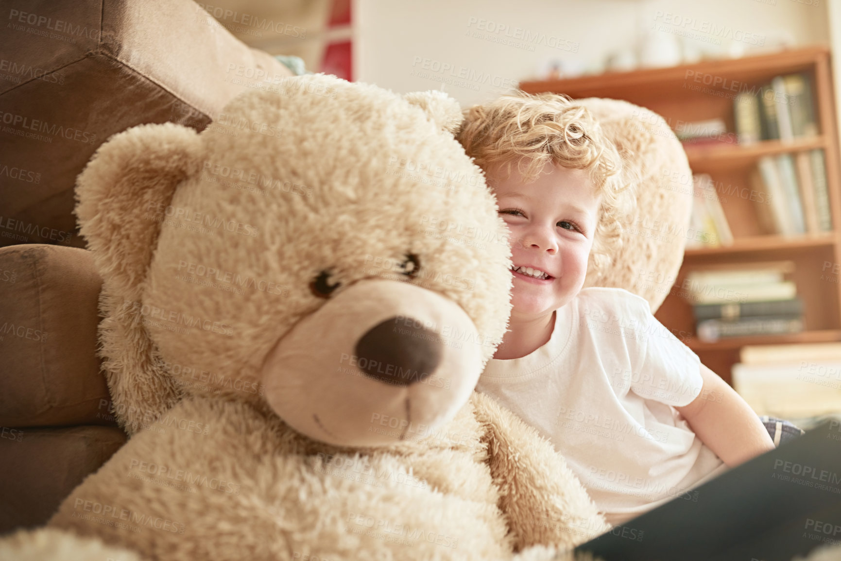Buy stock photo Portrait of an adorable little boy sitting alongside his teddy bear at home