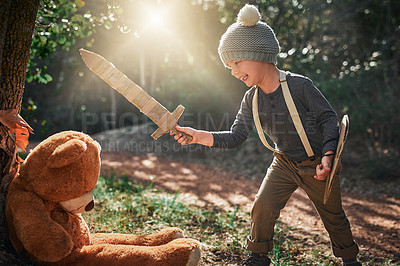 Buy stock photo Shot of an adorable little boy playing with a cardboard sword and shield outside