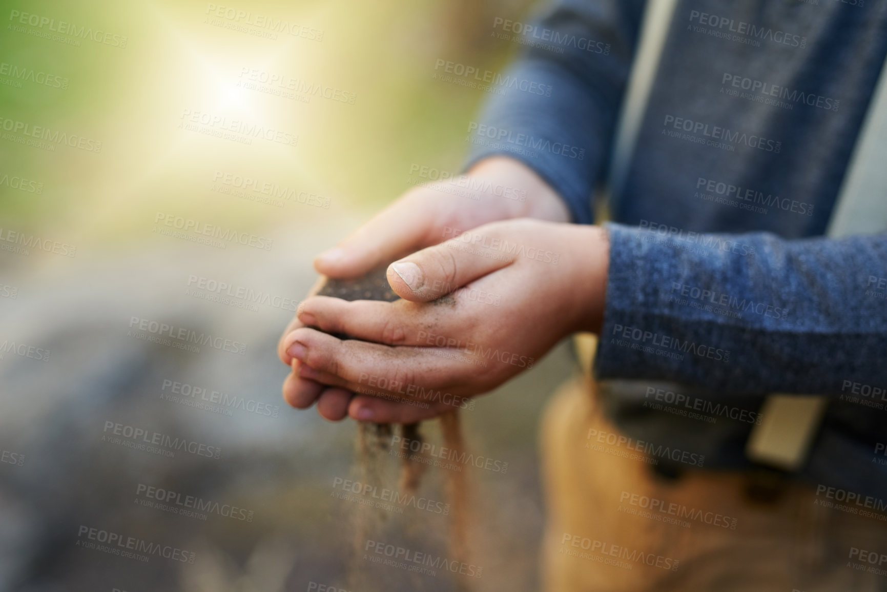 Buy stock photo Child, hands and sand in garden outdoor with sensory play to explore environment, curious and development. Kid, person and playful with soil for earth day, creative activity and fun game in nature