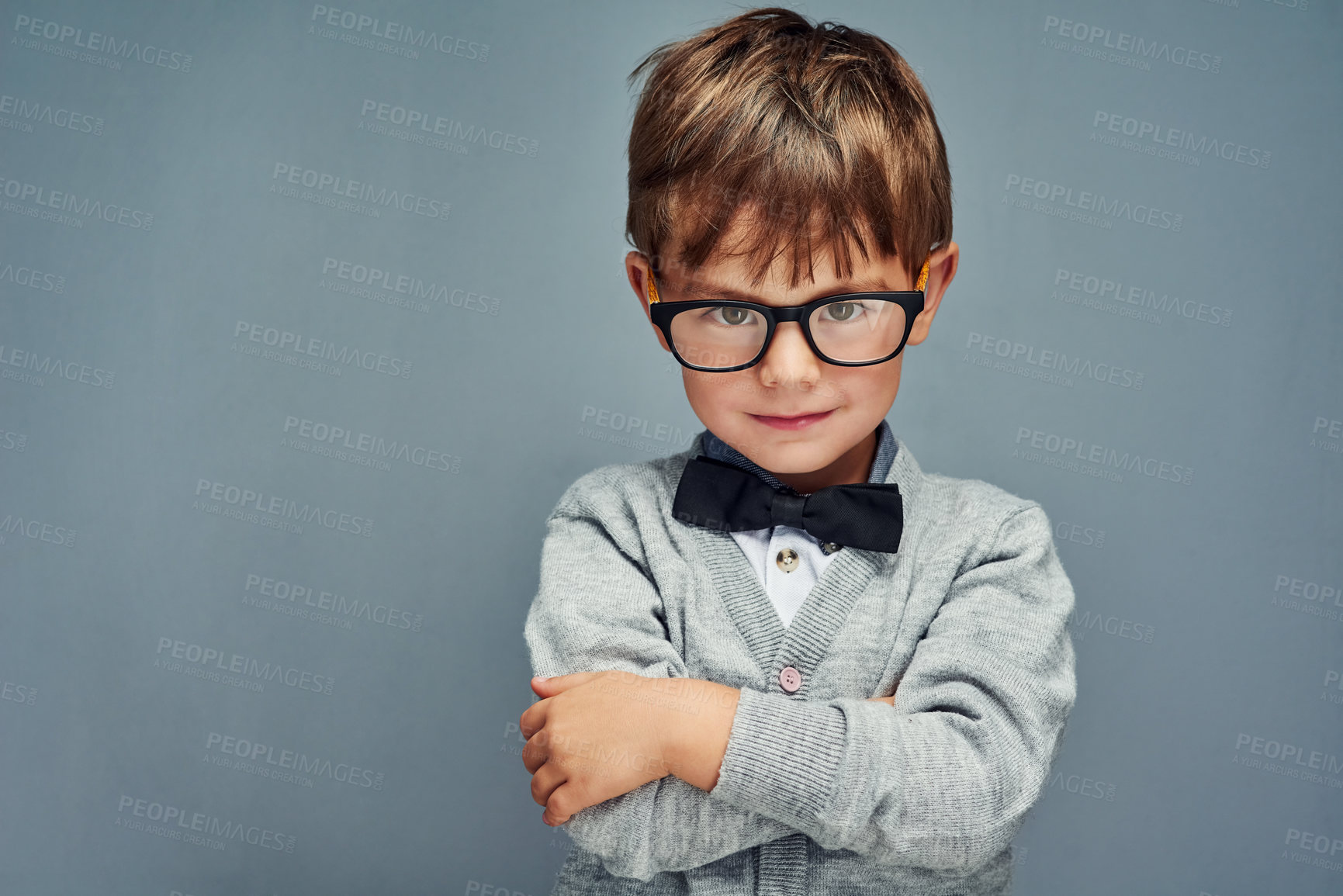Buy stock photo Studio portrait of a smartly dressed little boy posing confidently against a gray background