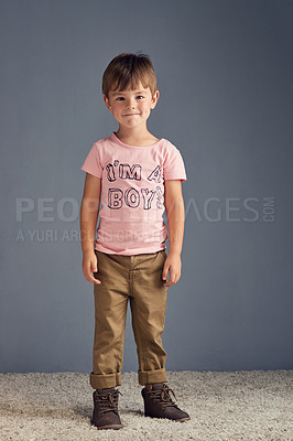 Buy stock photo Studio portrait of a boy wearing a t shirt with “I’m a boy” printed on it against a gray background