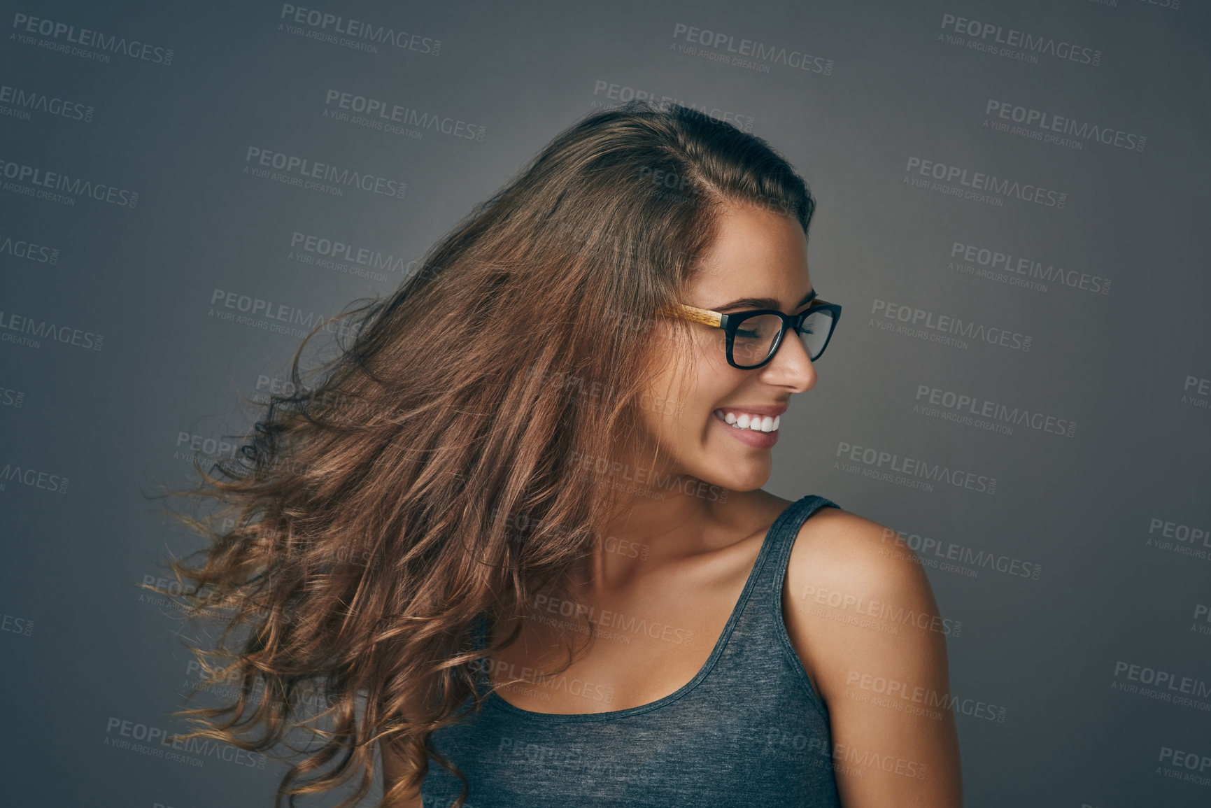 Buy stock photo Studio shot of an attractive young woman wearing glasses