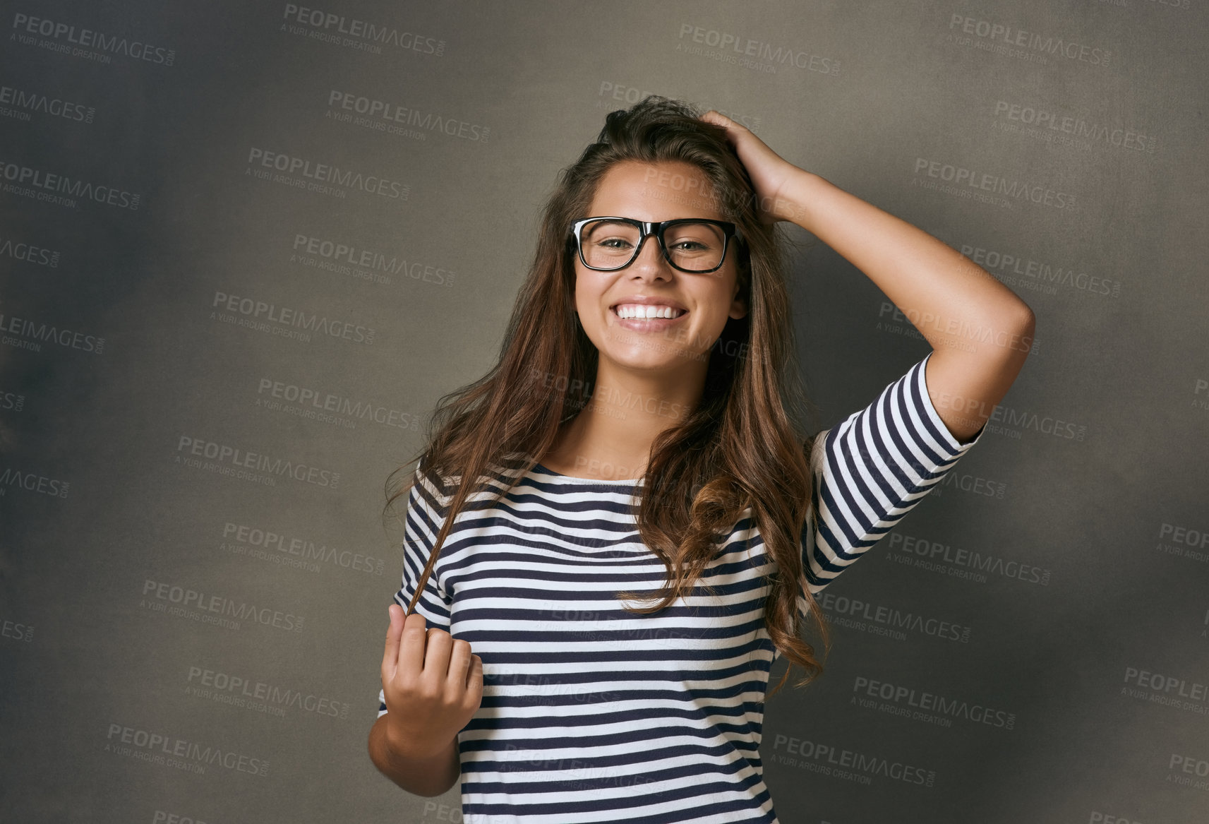 Buy stock photo Woman, glasses and portrait with confidence, optometry and playful on gray studio background. Female person, face and happy for eyewear, sight and smile with casual outfit, clear vision and wellness