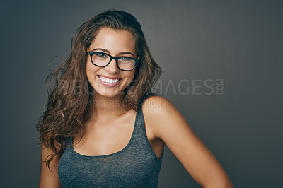 Buy stock photo Woman, glasses and portrait with happiness and mockup from eyewear. Gray background, studio and mockup with young female person and model with beauty and casual style with a smile and eye care