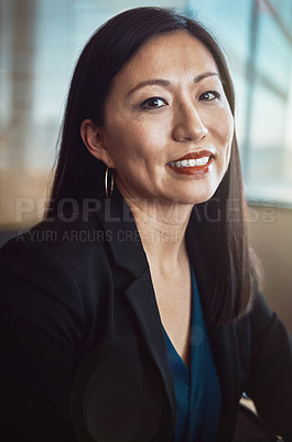 Buy stock photo Cropped portrait of a mature businesswoman sitting in her office