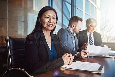 Buy stock photo Cropped portrait of a mature businesswoman sitting in the boardroom during a meeting