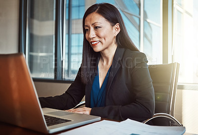 Buy stock photo Cropped shot of a mature businesswoman working on her laptop in the office