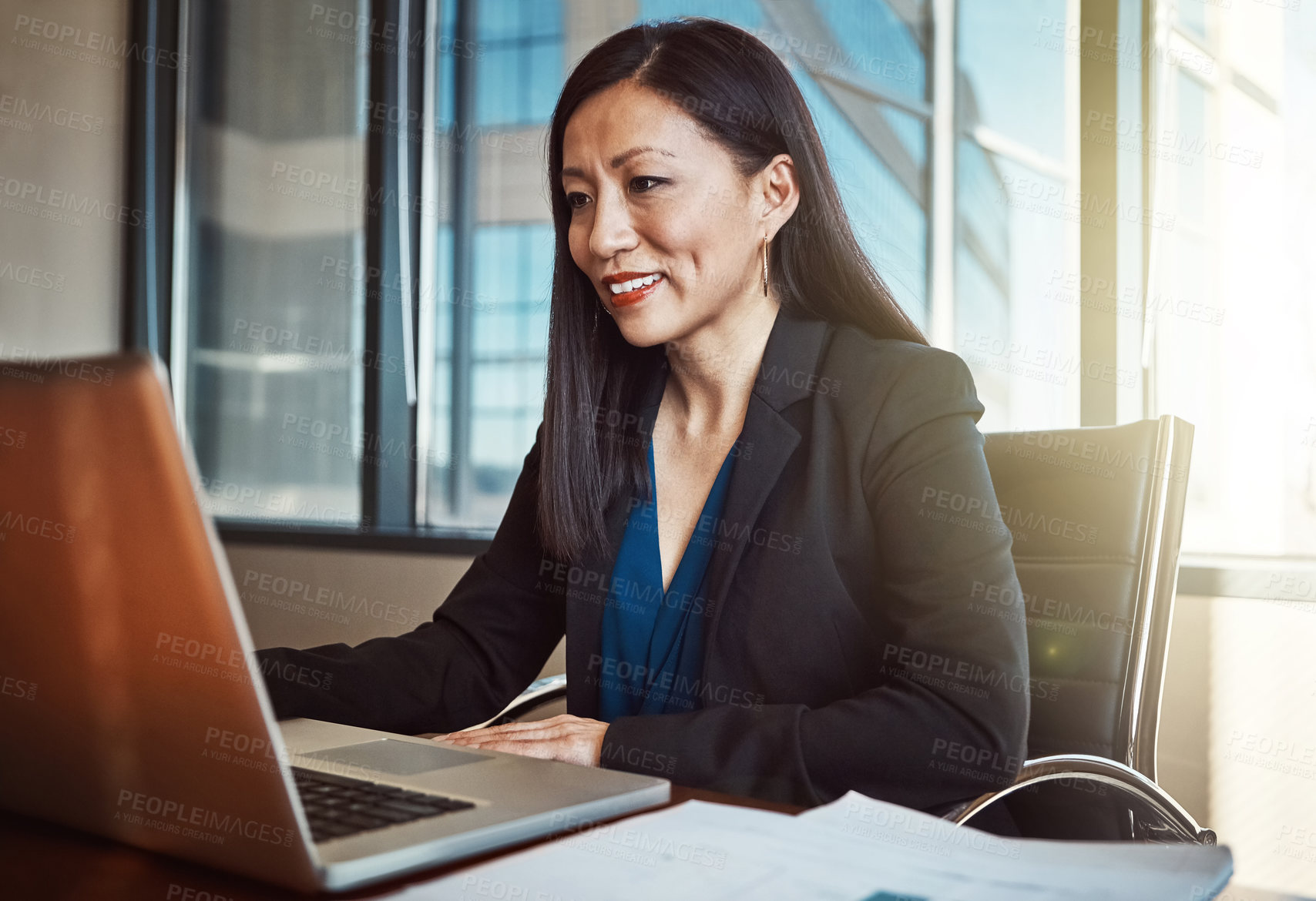 Buy stock photo Cropped shot of a mature businesswoman working on her laptop in the office