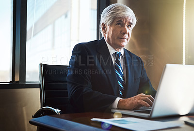 Buy stock photo Cropped shot of a mature businessman working on his laptop in the office