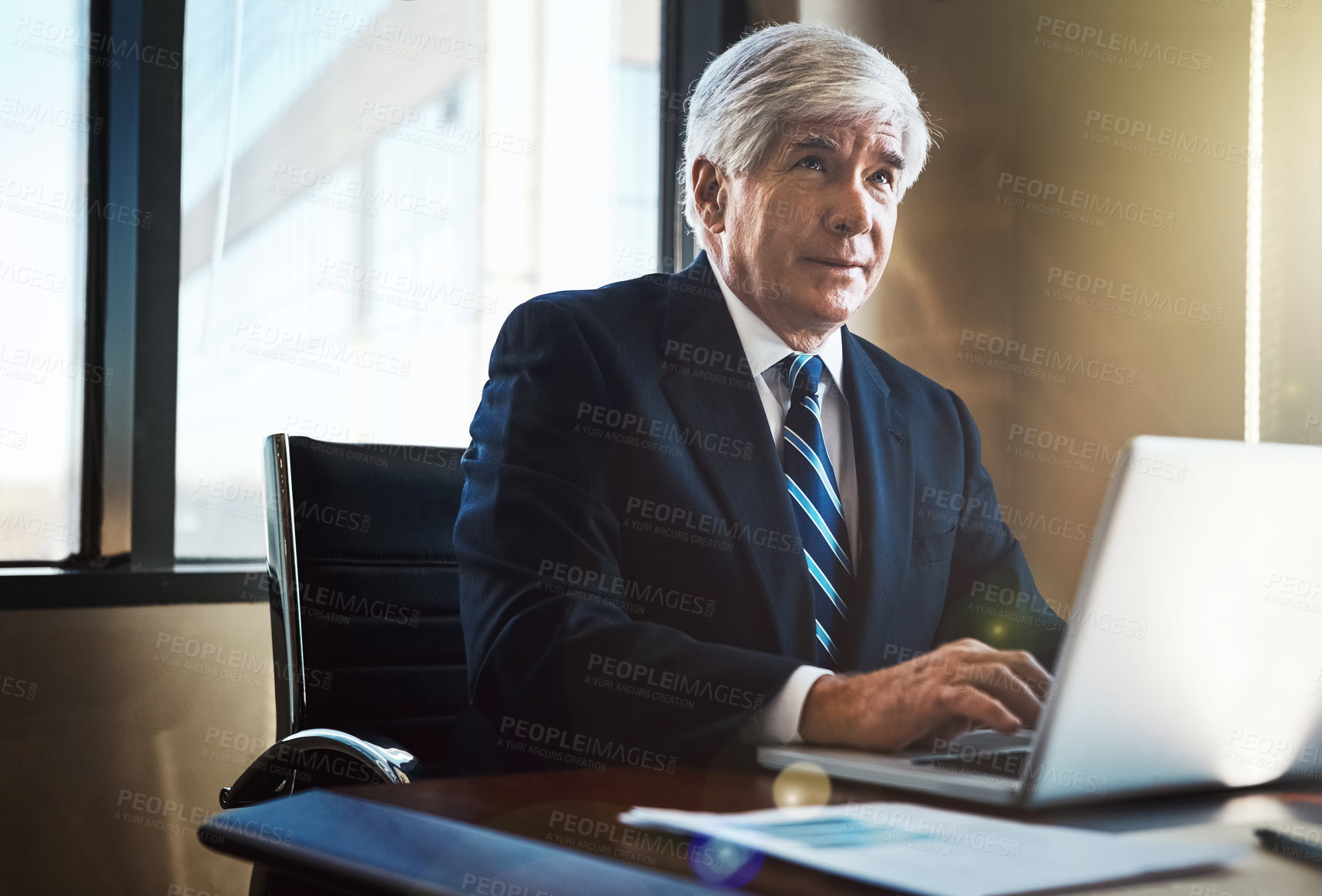 Buy stock photo Cropped shot of a mature businessman working on his laptop in the office