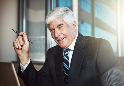 Buy stock photo Cropped portrait of a mature businessman working on his laptop in the office