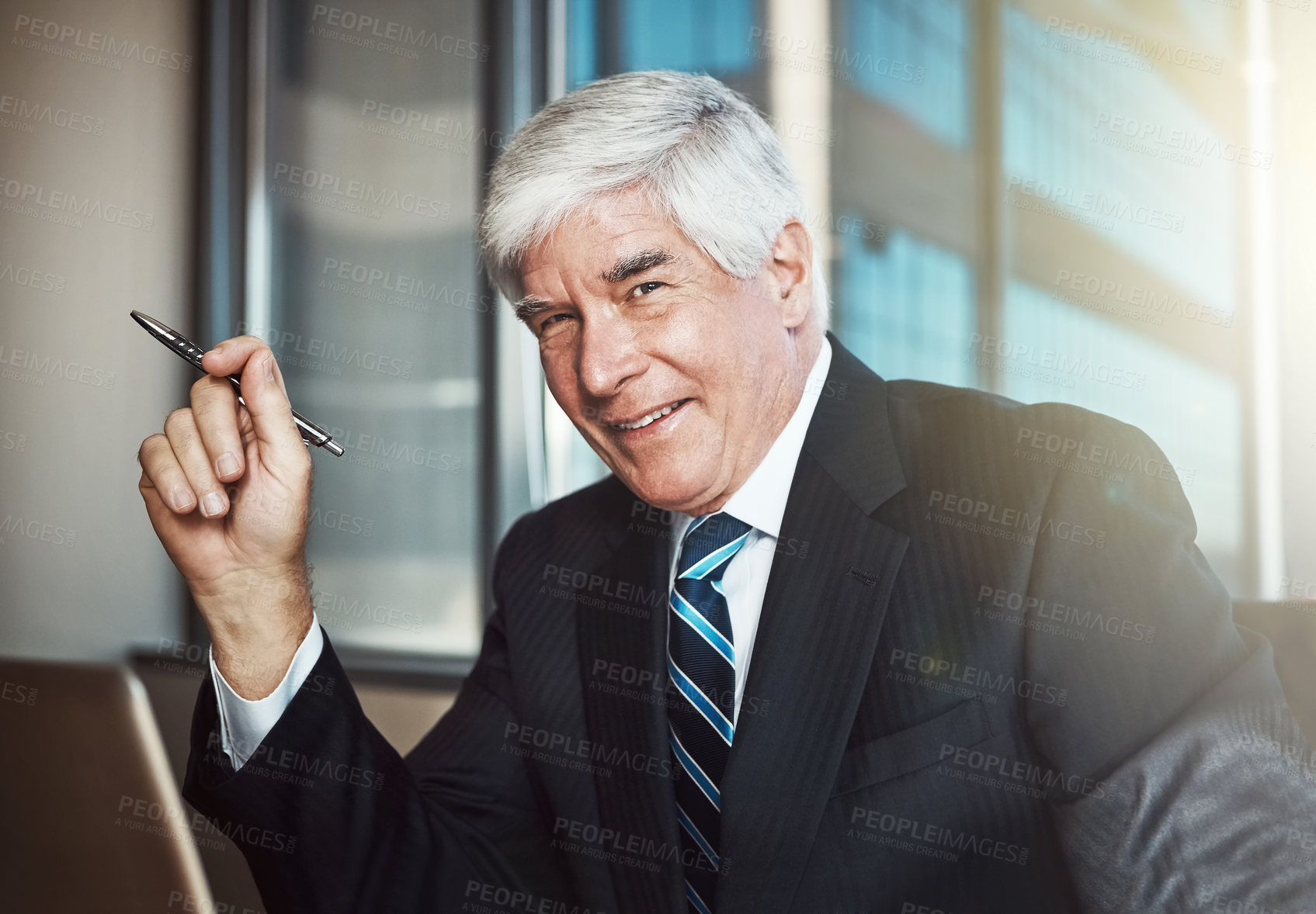 Buy stock photo Cropped portrait of a mature businessman working on his laptop in the office