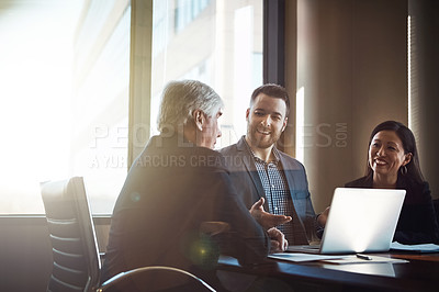 Buy stock photo Cropped shot of three businesspeople working in the boardroom