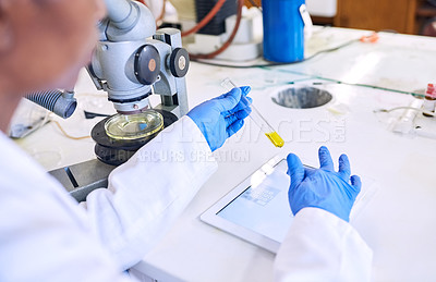 Buy stock photo Shot of a female scientist working on a digital tablet in a lab