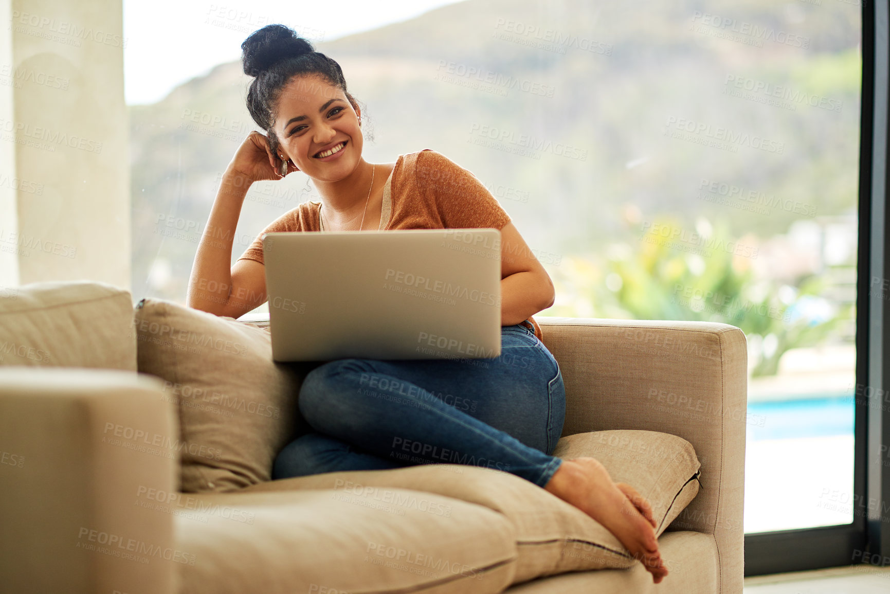 Buy stock photo Shot of a beautiful young woman using a laptop at home