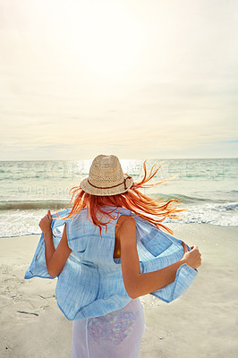 Buy stock photo Shot an attractive young woman enjoying a day at the beach