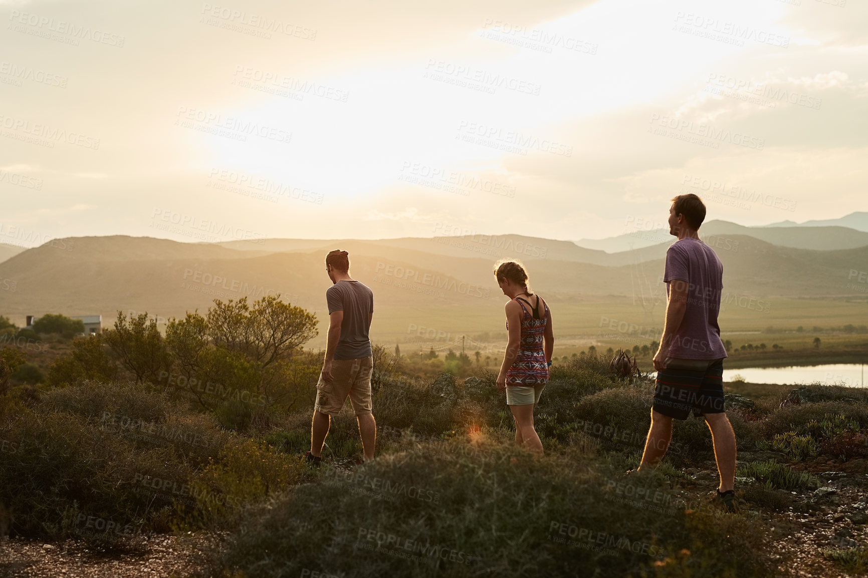 Buy stock photo Rearview shot of three young hikers on a mountain trail