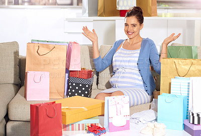 Buy stock photo Shot of a pregnant woman surrounded with gifts at her baby shower