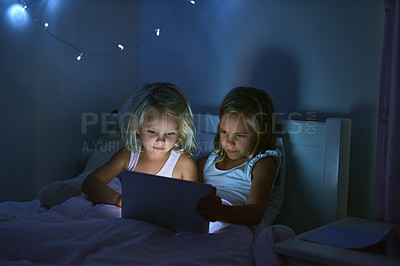 Buy stock photo Tablet, bedroom and kids in home at night for streaming movie, video or cartoon together. Digital technology, girl and children in bed for game, internet addiction and sisters reading story to relax