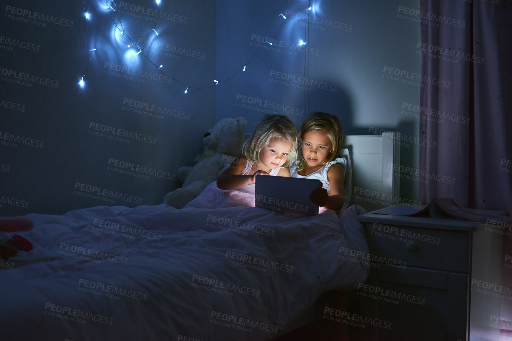 Buy stock photo Tablet, bedroom and children in home at night for streaming movie, video or cartoon together. Digital technology, girls and kids in bed for game, internet addiction and sisters reading story to relax