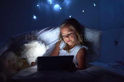 Buy stock photo Shot of a little girl using a digital tablet before bedtime