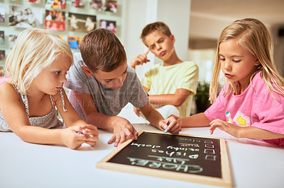 Buy stock photo Kids, writing and chalkboard in home, list and group for help, teamwork or development in morning. Children, blackboard or notes for siblings, chores schedule or planning for cleaning in family house