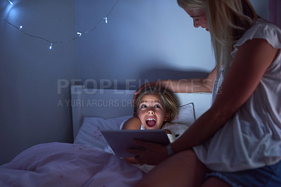 Buy stock photo Mother, daughter and surprise in bedroom with reading story at night, tablet for kids with digital book. Mom, girl child and dark with shocked expression in home for family, wow for video education