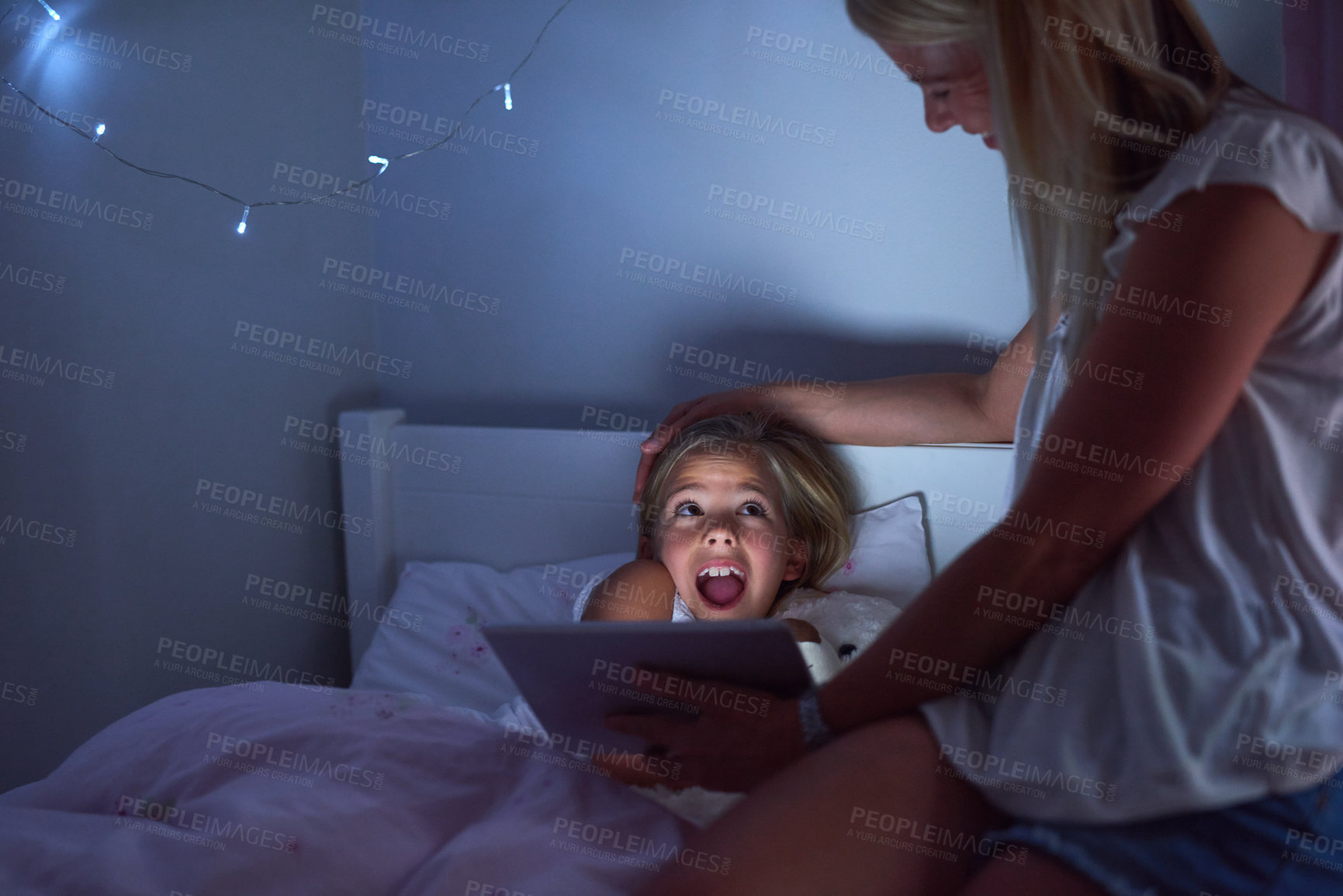 Buy stock photo Mother, daughter and surprise in bedroom with reading story at night, tablet for kids with digital book. Mom, girl child and dark with shocked expression in home for family, wow for video education