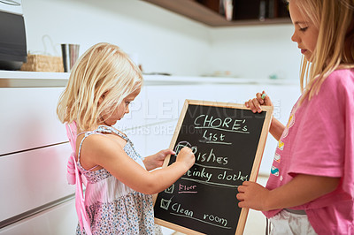 Buy stock photo Children, chalkboard and checklist of chores in home, writing or reading for help, team or development in morning. Kids, blackboard and together with schedule planning for cleaning in family house