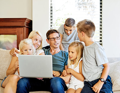 Buy stock photo Shot of a family using a laptop together at home