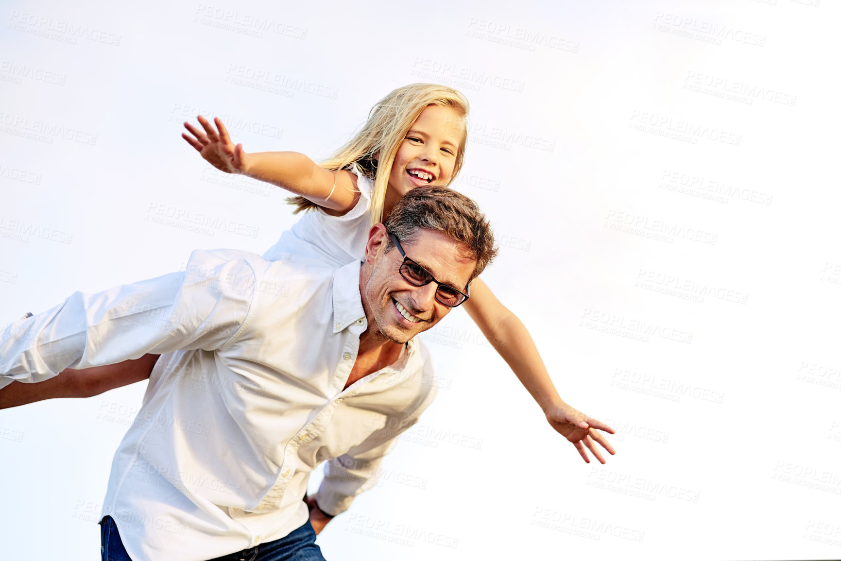 Buy stock photo Shot of a father piggybacking his daughter outdoors