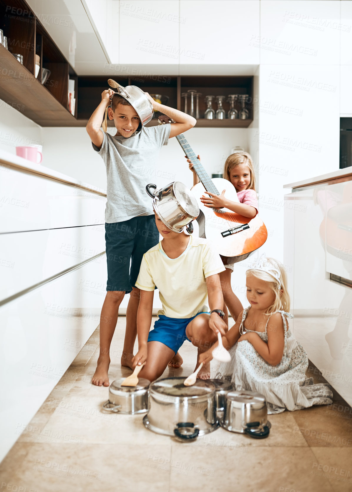 Buy stock photo Portrait of little siblings playing music on a guitar and a set of pots at home