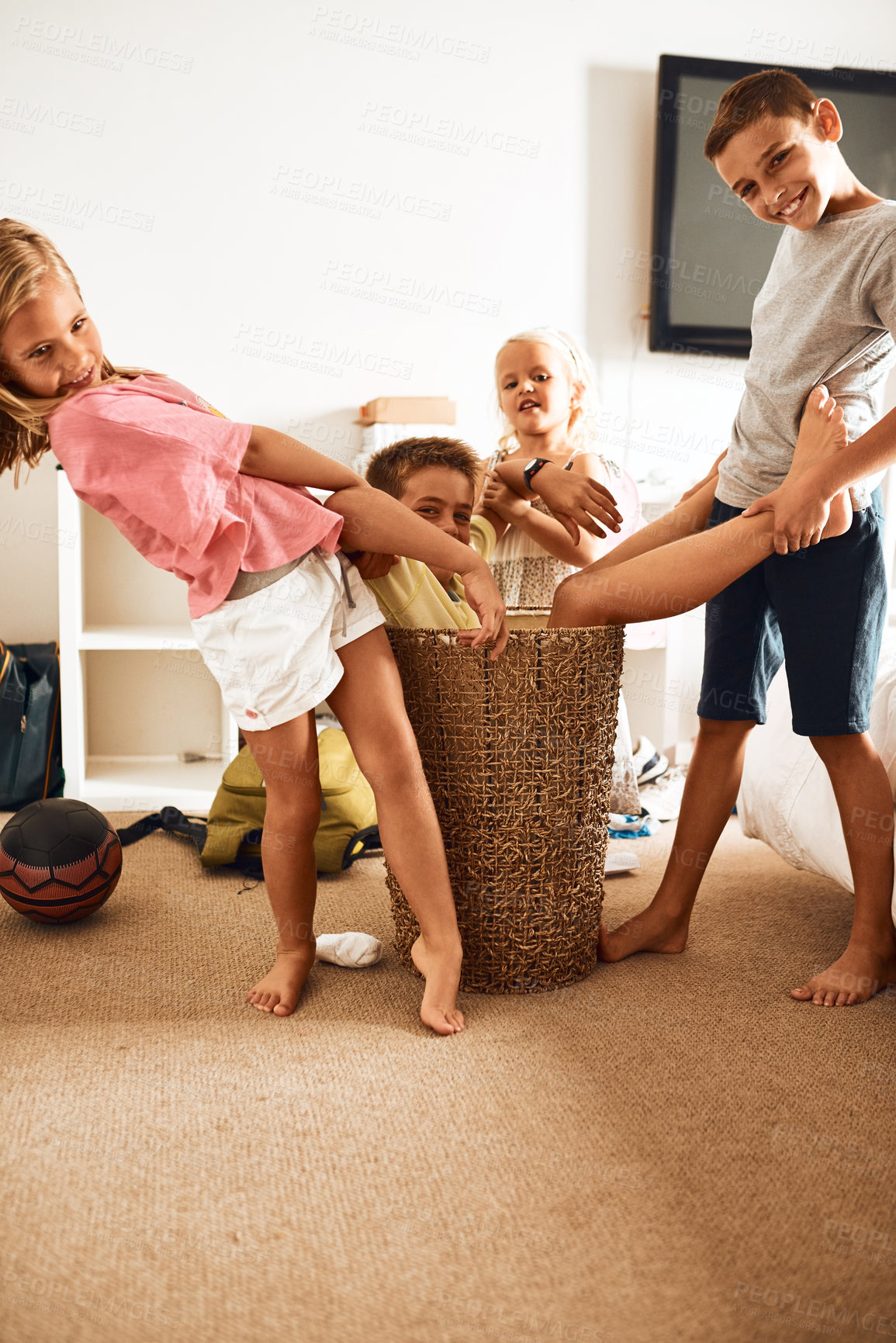 Buy stock photo Portrait, children and laundry basket in home for playing, silly and bonding together with connection. Family, sisters and brothers with happiness for games, creativity and relationship of siblings