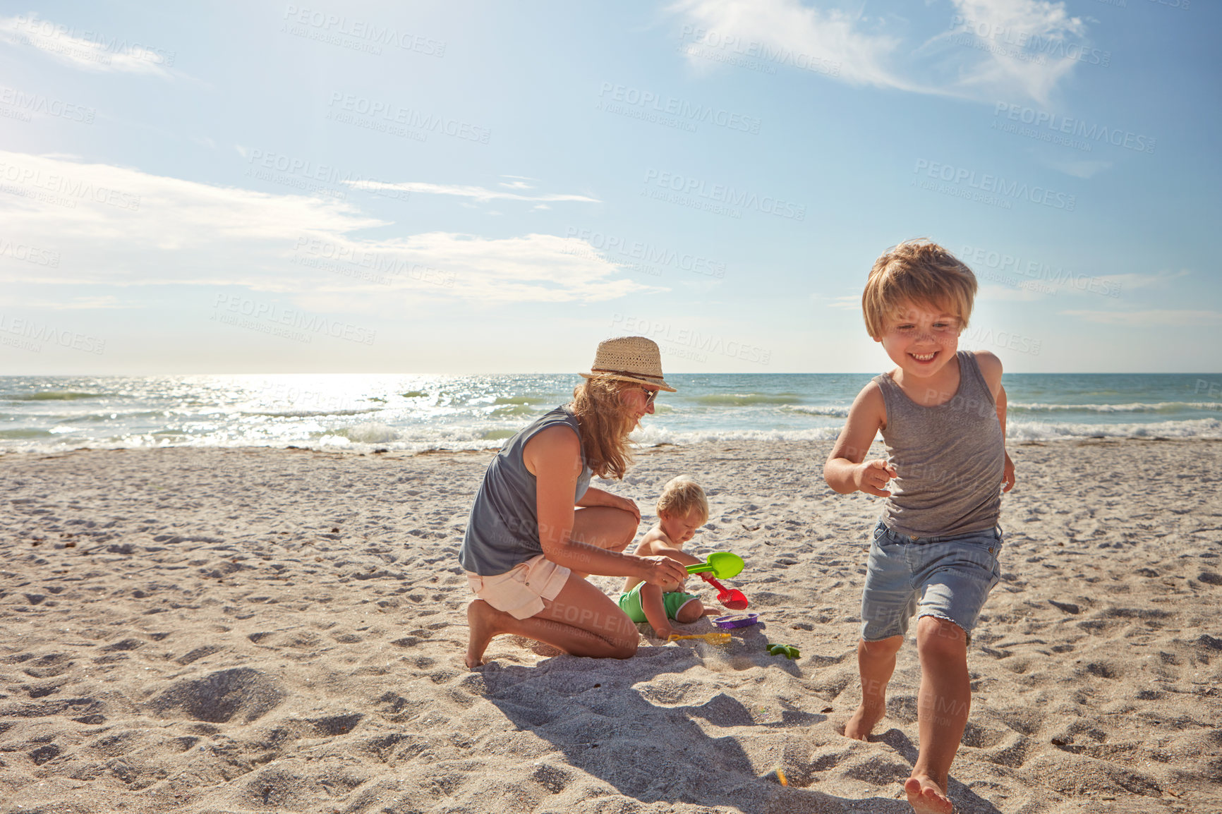 Buy stock photo Happy, mother and children playing on the beach on family vacation, holiday or adventure in summer. Boy, woman and kids with outdoor ocean for fun energy and happiness with game while running