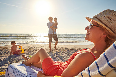 Buy stock photo Woman, relax and blue sky on beach chair with family together, adventure and bonding in summer holiday. Happy, mother and father or child by ocean outdoor, travel and tropical vacation in Greece