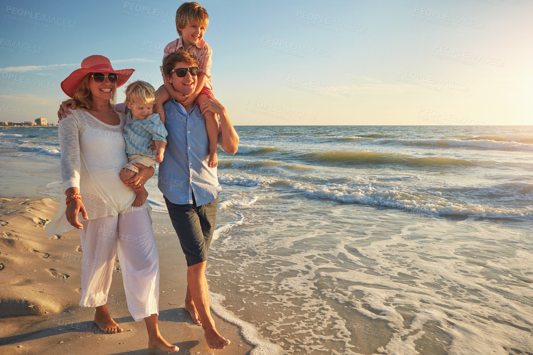 Buy stock photo Happy family, beach holiday and walking, smile for vacation on tropical island. Man, woman and children together with sunglasses by ocean for travel with wellness, mockup space at sunset in Mauritius