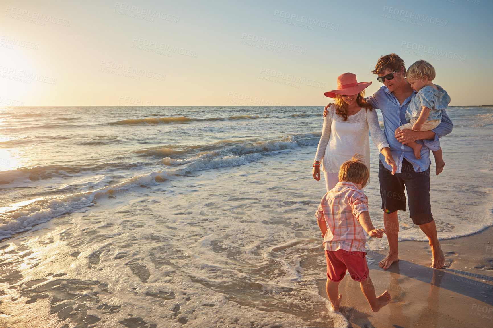 Buy stock photo Sand, holiday and walking for family, beach and bonding in trip, fun and outdoor in California. Sea, peace and children with parents, waves and water of ocean, relax and man with woman together