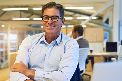 Buy stock photo Portrait of a confident businessman posing at his desk in the office