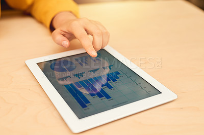 Buy stock photo Cropped shot of an unidentifiable businesswoman using her tablet at a table in the office