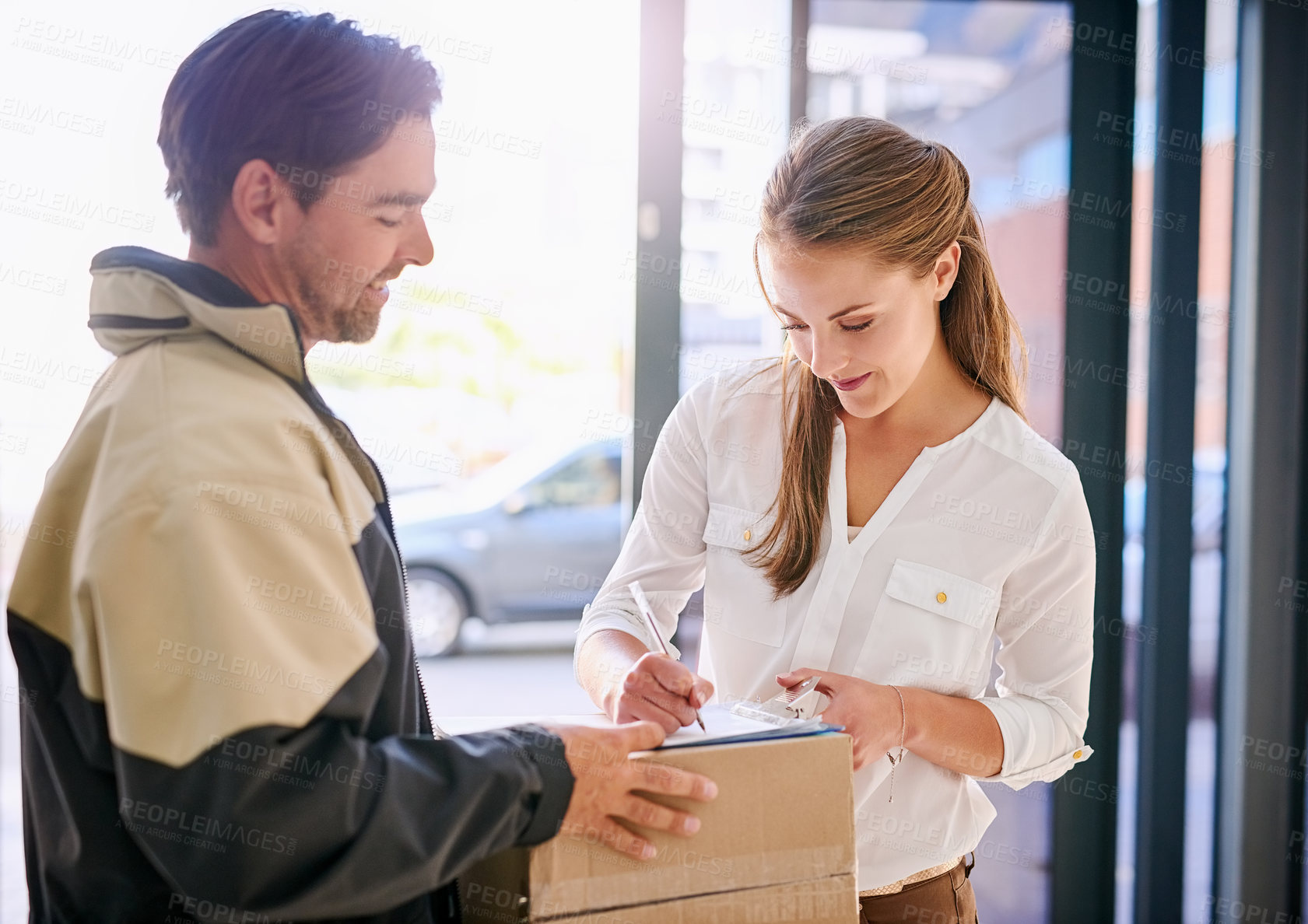 Buy stock photo Signing, delivery man and woman with package for courier drop off with receipt for company with lens flare. Shipping, business and parcel for customer in workplace with writing for order confirmation