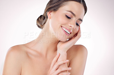 Buy stock photo Studio shot of a beautiful young woman posing against a grey background