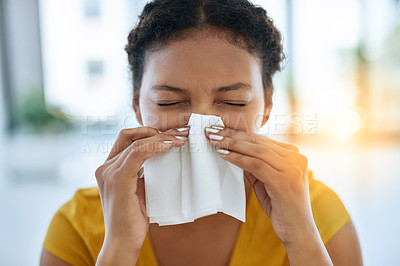Buy stock photo Shot of a young designer blowing her nose in an office