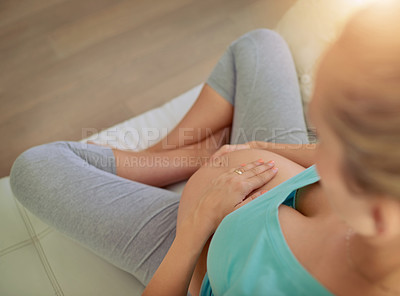 Buy stock photo Pregnant woman, hands and belly on couch in home, above and connection with movement, kicking or growth. Person, mother and stomach on sofa with love, touch and relax in living room at apartment