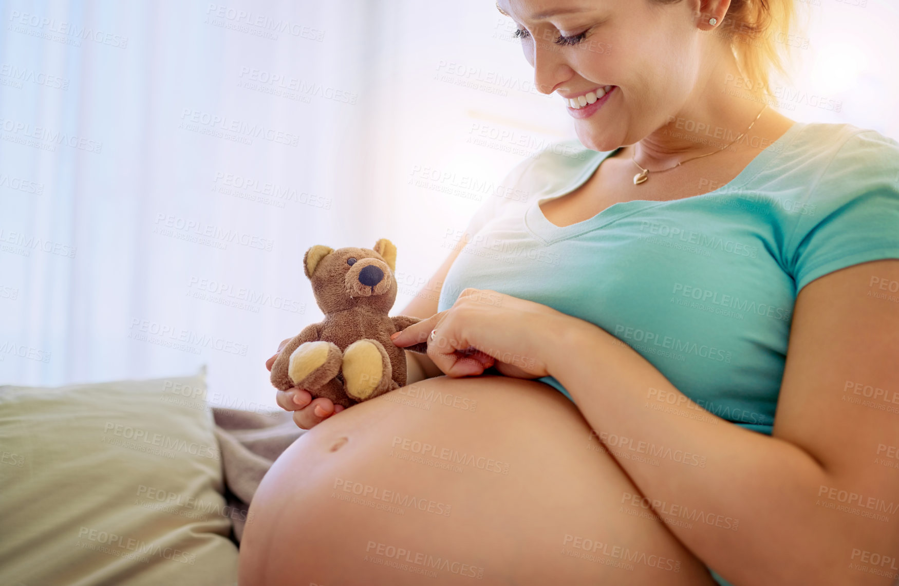 Buy stock photo Pregnant woman, bear toy and touch on sofa with love, connection and excited for baby in living room. Person, mother and plush teddy with play on couch with memory, reflection and care in home