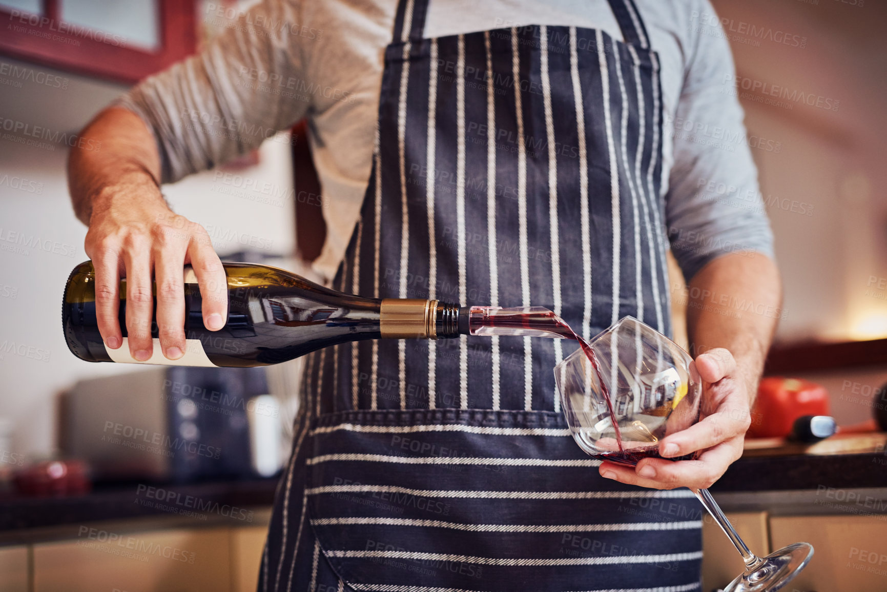 Buy stock photo Hands, wine bottle and person with apron for cooking, culinary hobby or beverage for relaxing. Alcohol, drink and glass in kitchen for break in home or apartment to prepare dinner or lunch meal